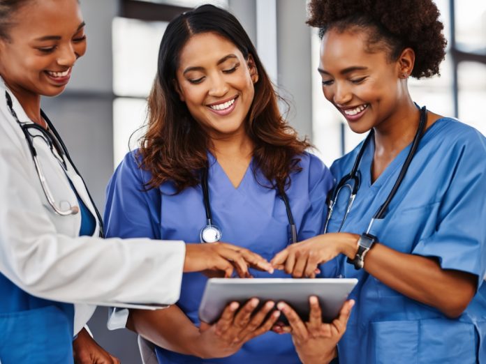 Healthcare professionals using AI technology in a modern clinic.