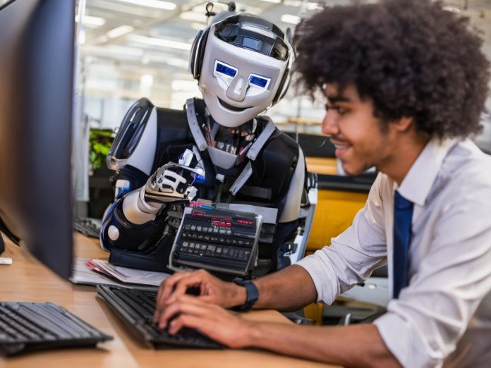 A human and robot collaborating in a modern office.