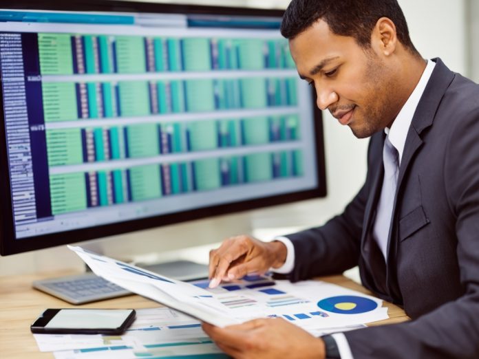 Financial analyst assessing data to understand AI-related risks in a modern office setting.