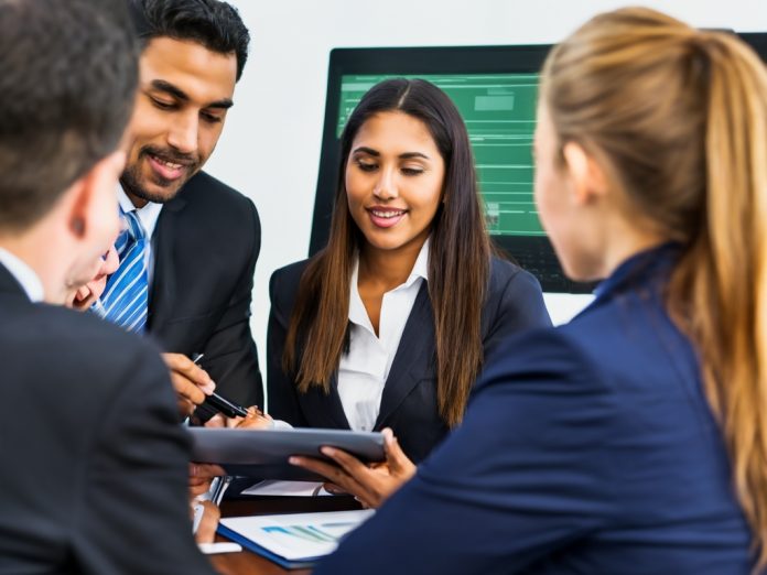 Group of professionals discussing technology in a modern courtroom setting