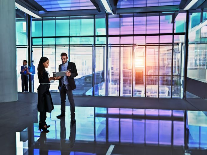 A modern office where people are engaged in creative collaboration aided by technology.