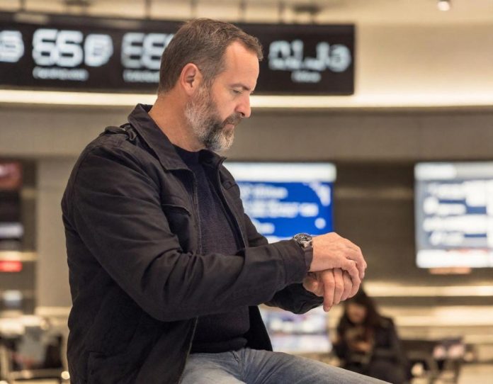 Traveler experiencing long wait times at modern airport border control area