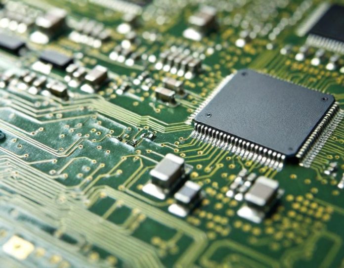 Detailed view of semiconductor chip circuitry under magnification in laboratory setting