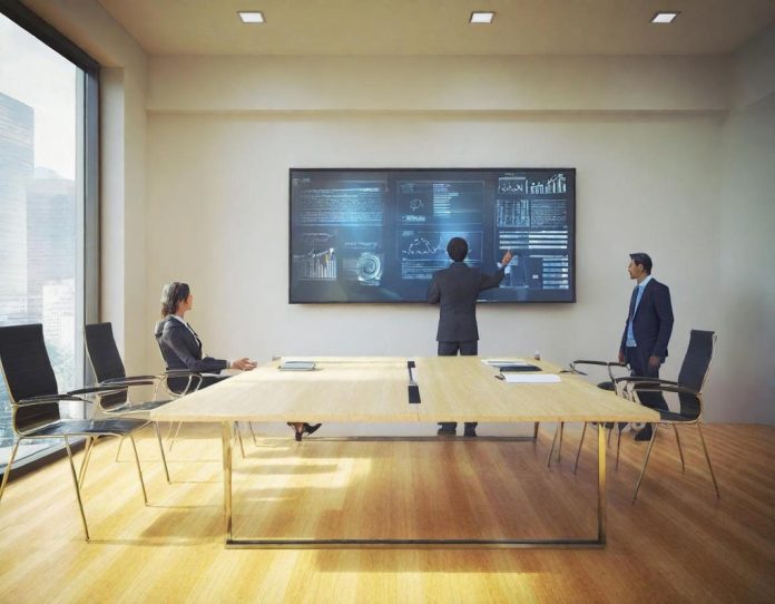 Team collaboration in modern office discussing workflow optimization with digital displays