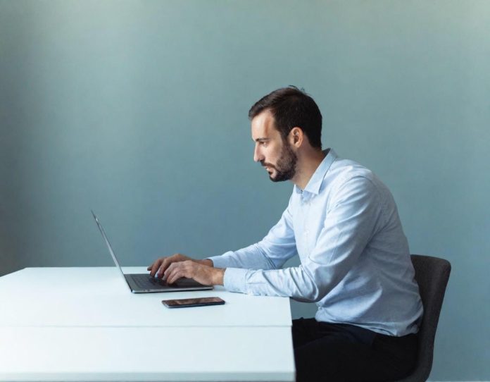 Professional working with dual monitors in modern office, representing enterprise technology and productivity